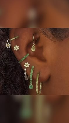 a close up of a person's ear with three different types of piercings