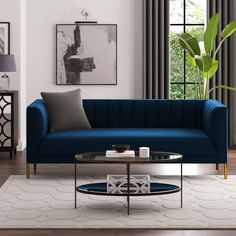 a living room scene with focus on the couch and coffee table in front of the window