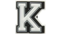 the letter k is made up of black and white plastic with silver letters on it