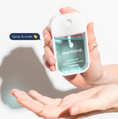 a person holding an air freshener in their hand with the words touchland on it