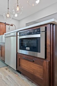 a kitchen with an oven, dishwasher and cabinets in it's center