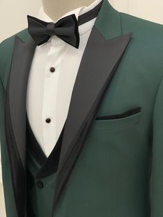 a green tuxedo with white shirt and black bow tie