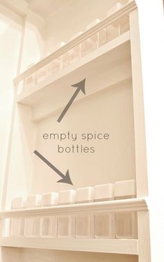 an empty shelf with two bottles and arrows pointing to the empty space between it's shelves