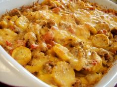 a casserole dish with meat, cheese and potatoes