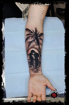 a person with a palm tree tattoo on their arm