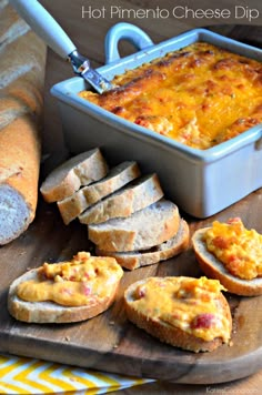 baked bread with cheese dip in a blue casserole dish on a cutting board