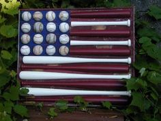 an american flag made out of baseballs and bats sitting on top of a wooden box