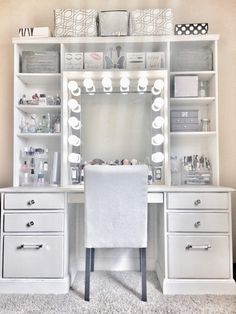 a white desk with lots of drawers and a mirror on the top shelf above it