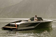 a man driving a motor boat in the water