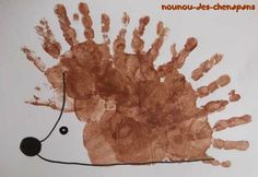 a hand print of a hedgehog on a white paper with an orange border around it