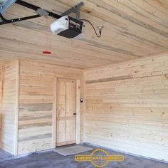 an empty room with wood paneling and security camera