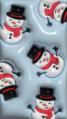 four snowmen with hats, scarfs and gloves in a blue tray on top of each other