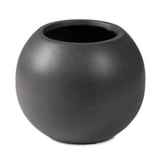 a black vase sitting on top of a white table