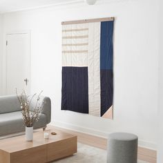 a living room with a couch, coffee table and rug