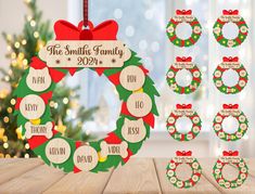 a christmas wreath with personalized name tags on it and other holiday decorations around the wreath