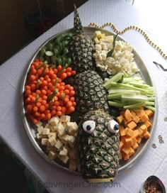 a plate filled with different types of food on top of a white tablecloth covered table