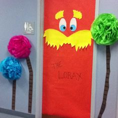 the lorax door decoration is decorated with tissue paper and pom poms