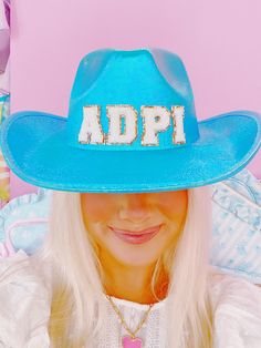 a woman wearing a blue hat with the word adpi on it