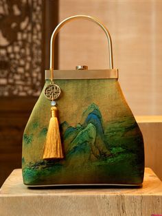 Size: 18*9.5*20cm (bottom length*width*height), 9.3cm (handle height) Weight: 0.376kg Material: Mulberry silk Crafts: Embroidery Usage: Handbag Feature: Flaunting a timeless design of printing rivers and mountains, this piece is emblematic of breathtaking vistas and affluence. Its remarkable motif conveys grandeur and majesty, exemplifying its rich history and singular cultural flair. This handbag is constructed with exquisite mulberry silk fabric, delivering a soft and gentle caress to the touc Mulberry Leaf, Statement Handbag, Mulberry Silk Fabric, Embroidered Handbag, Mulberry Silk, Clutch Handbag, Evening Bags, Fashion Bags, Vintage Inspired