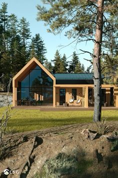 an artist's rendering of a house in the woods with grass and trees around it