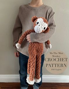 a young boy holding a stuffed animal in his arms with the words mr the monkey crochet pattern on it