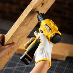 a person using a drill to fix a piece of wood