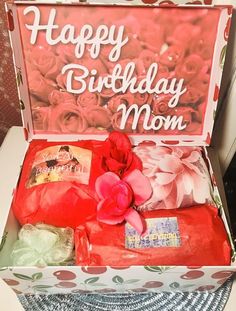 an open birthday box with flowers and candles