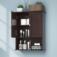 a bathroom cabinet with shelves and toiletries on it's sides, against a blue wall