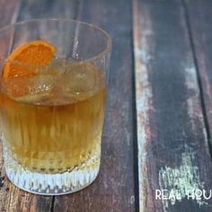 an orange slice sitting on top of a glass filled with liquid