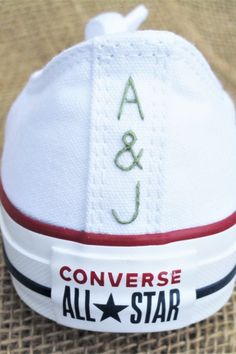 the converse all star logo is embroidered on top of white shoes