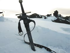 a pair of skis sitting on top of a snow covered slope