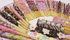 there are many decorated cookies and candy sticks on the table with pink polka dot dots