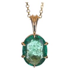 Displayed is a classic and unique emerald solitaire necklace set in 14K yellow gold. This gorgeous solitaire pendant carries a full 1.88-carat emerald in a six-claw prong setting. Fully faceted, this gemstone showcases very good shine, rare dark green color, great size, and clarity. An ideal solitaire, perfect for everyday use! Setting Style: Solitaire - Prong Setting Material: 14K Yellow Gold Gold Weight: 1.3 grams Main Stone: Emerald Shape: Oval Cut Approx Weight: 1.88-carats Color: Green Clar Dark Green Gemstone, Pink Pixel Art, Green Gemstone Necklace, Green Stone Pendant, The Crown Jewels, Solitaire Necklace, Dark Green Color, Claw Prong, Solitaire Necklaces