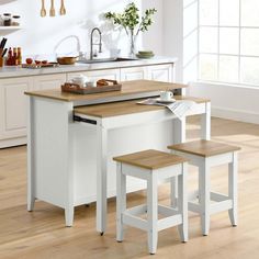 a kitchen island with two stools next to it