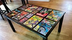 a table with many comics on it in the middle of a living room and dining room