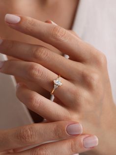 a woman's hand with a diamond ring on it