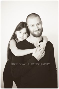 a man and woman hugging each other in black and white