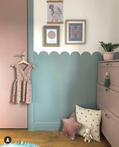 a baby's room with pink and blue walls