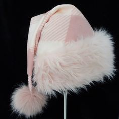 "This festive Santa hat is made up in a pastel pink gingham check fleece fabric. The fabric is a soft quality poly fleece fabric, cozy and warm. So if you plan on wearing it in the winter outdoors this is a good choice. The hat is accented with a long pile soft pink faux fur fabric trim. Proportions of the hat are generous and will fit most head sizes, ladies or gents. The styling is a slouch cone, traditional Santa look. Measurement for opening for your head is 25\" circumference and the length Pink Wide Brim Hat For Winter, Pink Wide Brim Felt Hat For Winter, Pink Wide Brim Mini Hat For Winter, Pink Felt Hat With Curved Brim For Winter, Pink Winter Felt Hat With Curved Brim, Pink Curved Brim Felt Hat For Winter, Winter Pink Cap, Pink Mini Hat For Winter, One Size Fits Most, Pink Winter Mini Hat One Size Fits Most