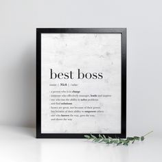 a framed poster with the words best boss on it and an olive branch next to it