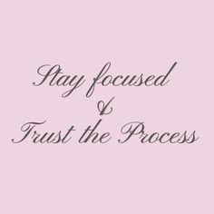 the words, stay focused and trust the process are written in black on a pink background