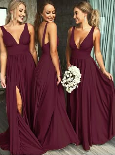 three women in long dresses standing next to each other