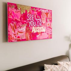 a pink painting hanging on the wall above a bed