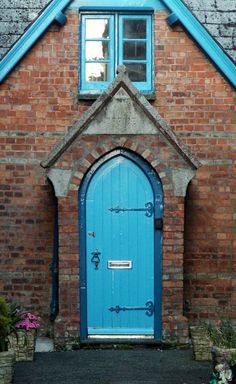 a blue door in front of a brick building