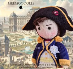 a knitted doll wearing a black hat and blue jacket with yellow trim, standing in front of a cityscape