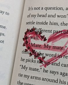 an open book with writing on it and a pink heart drawn in the pages next to it