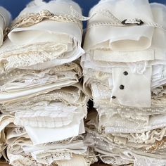 a pile of white wedding garters sitting on top of a wooden table