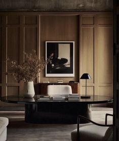 a living room filled with furniture and a large vase on top of a coffee table