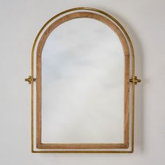 an arched mirror hanging on the wall