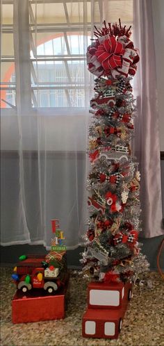 a christmas tree decorated with red and silver ornaments